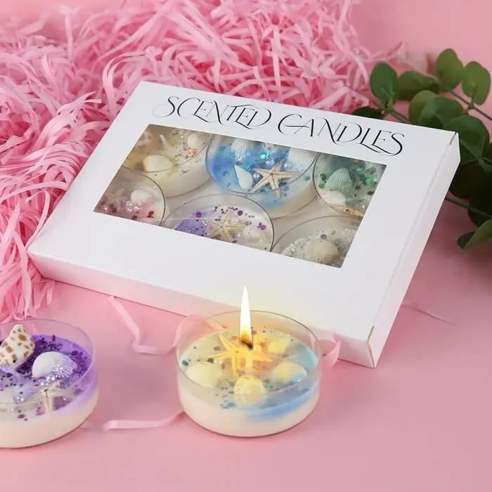 Coffret cadeau de bougies parfumées sur le thème des coquillages avec accents de perles et de paillettes