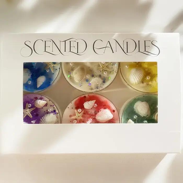 Coffret cadeau de bougies parfumées sur le thème des coquillages avec accents de perles et de paillettes