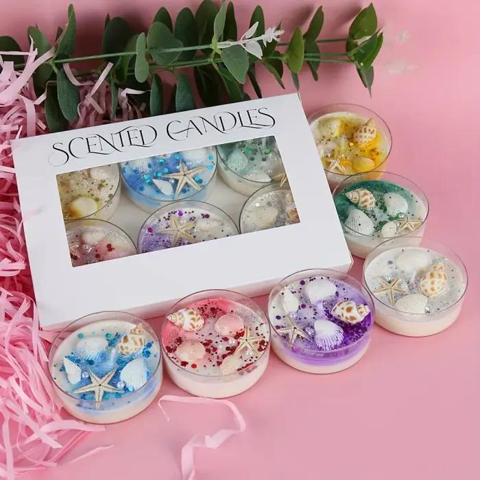 Coffret cadeau de bougies parfumées sur le thème des coquillages avec accents de perles et de paillettes