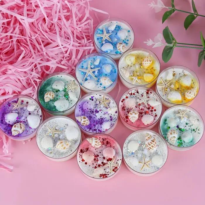 Coffret cadeau de bougies parfumées sur le thème des coquillages avec accents de perles et de paillettes